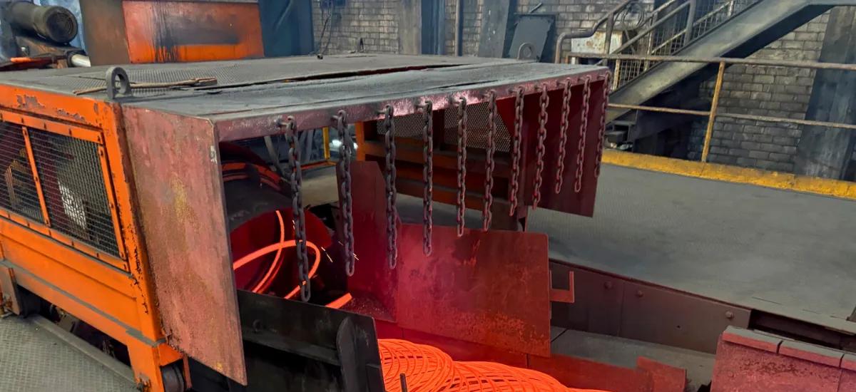 A close up of 8-millimeter wire rod exiting laying head onto cooling conveyor at Stahl Gerlafingen’s new wire rod mill from Primetals Technologies. 