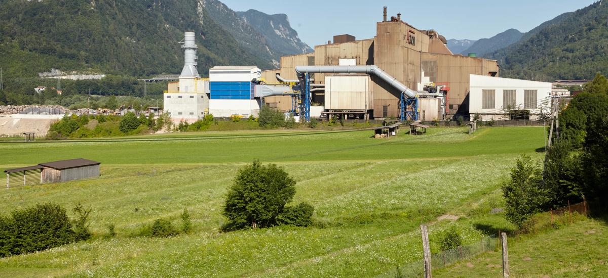 Overview of steel works at Acroni in Jesenice, Slovenia surrounded by green meadows and mountains