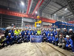 The Primetals Technologies team celebrates the first coil at Zhongshou Special Steel’s Arvedi ESP line. 
