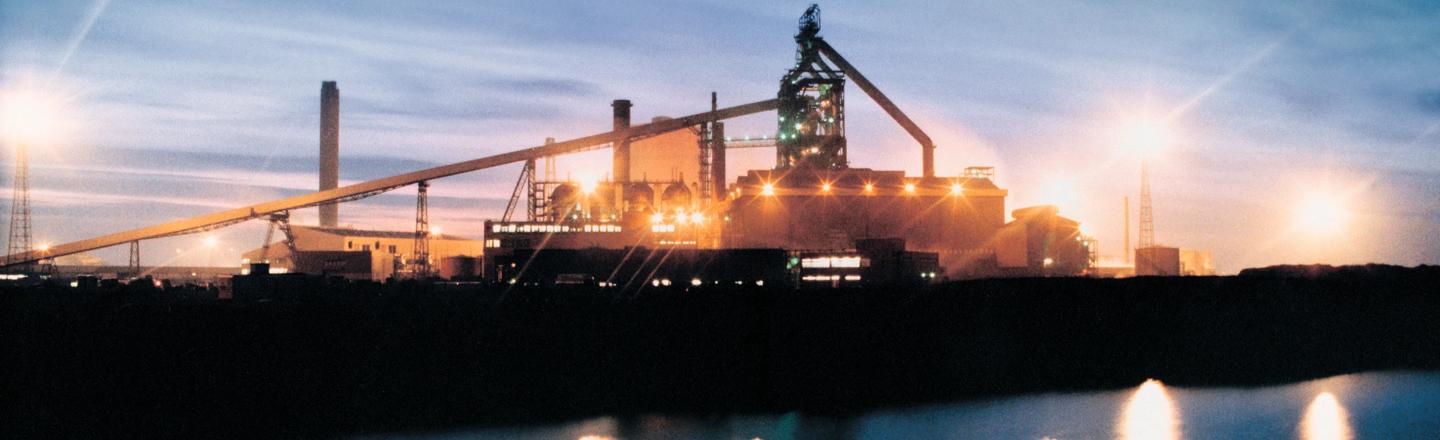 Landscape photograph of a blast furnace at sunset