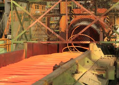 Morgan High Speed Laying Head as it lays stainless steel coiled bar onto the cooling conveyor