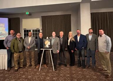Pictured are the Primetals Technologies and NLMK teams standing alongside the Gold Reliability Achievement Award. 