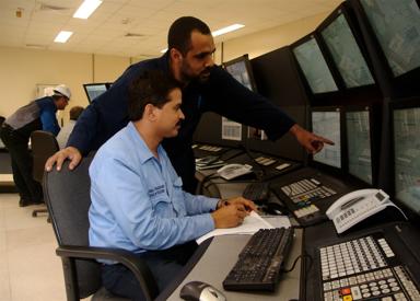 Two operators sitting in a DR control room