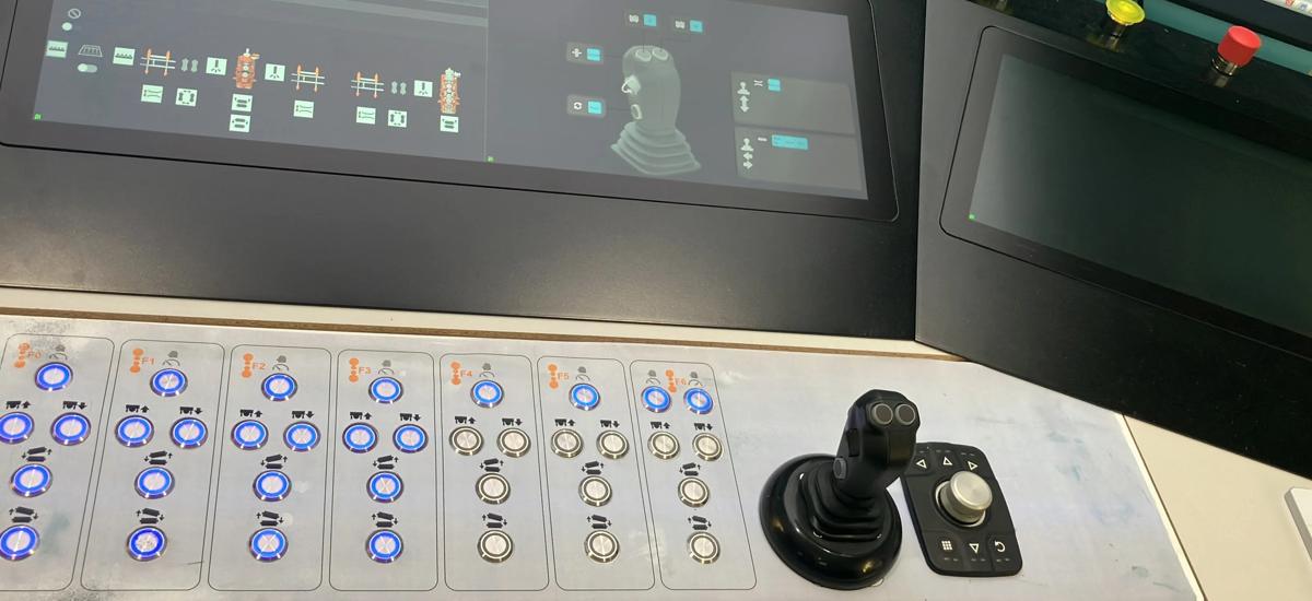 Joystick in focus at the central operation cockpit, allowing operators to control multiple functions based on the pre-selected HMI screen. The intuitive joystick interface enables quick and precise adjustments for efficient plant operation.