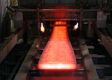 Hot steel slab moving through caster rolls during continuous casting