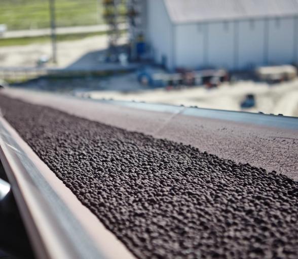 Iron ore pellets on a transport conveyor at ArcelorMittal Texas HBI (formerly voestalpine Texas).