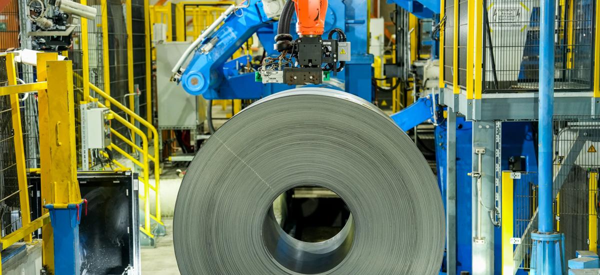 A precisely wound coil at the exit of a cold rolling mill, with evenly layered steel strip demonstrating excellent tension control and high surface quality.
