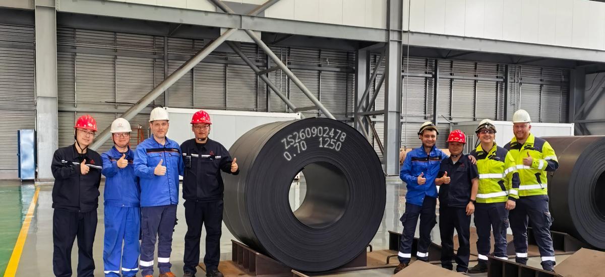 Part of the teams from Zhongsou Special Steel and Primetals Technologies after producing the first 0.7-millimeter thick coil. 