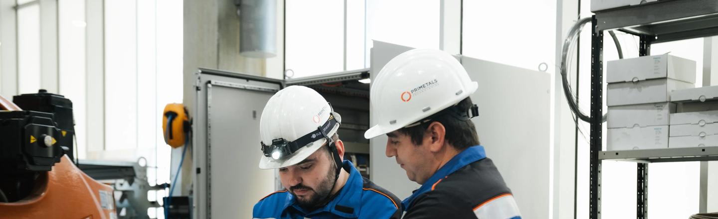 Two engineers looking up a technical documentation