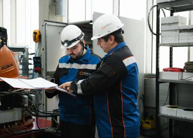 Two engineers looking up a technical documentation