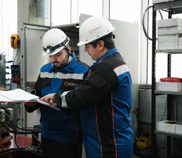 Two engineers looking up a technical documentation