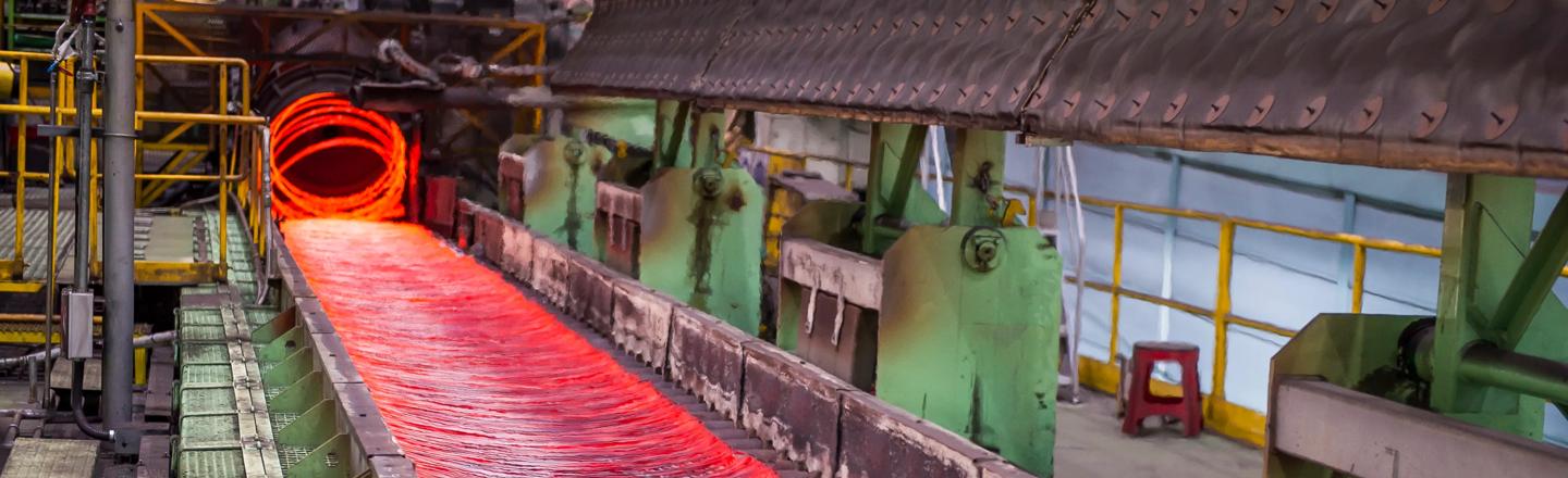 4-strand wire rod rolling mill showing hot rod exiting the Laying Head onto the Cooling Conveyor