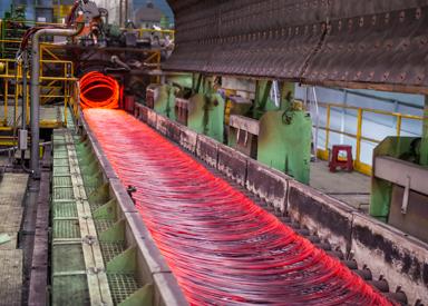 4-strand wire rod rolling mill showing hot rod exiting the Laying Head onto the Cooling Conveyor