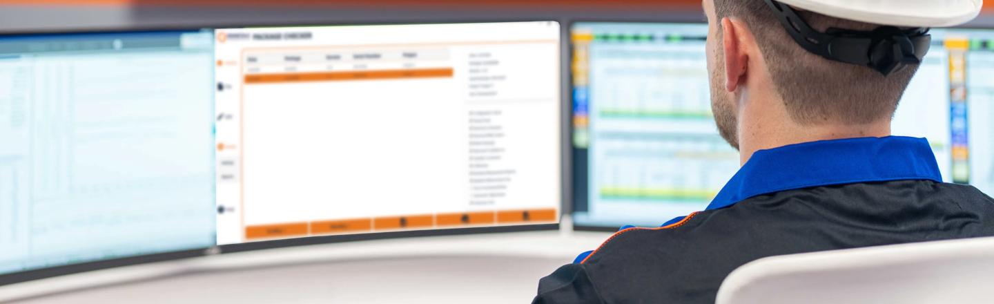 Operator monitoring continuous casting processes on multiple screens in a steel plant control room.