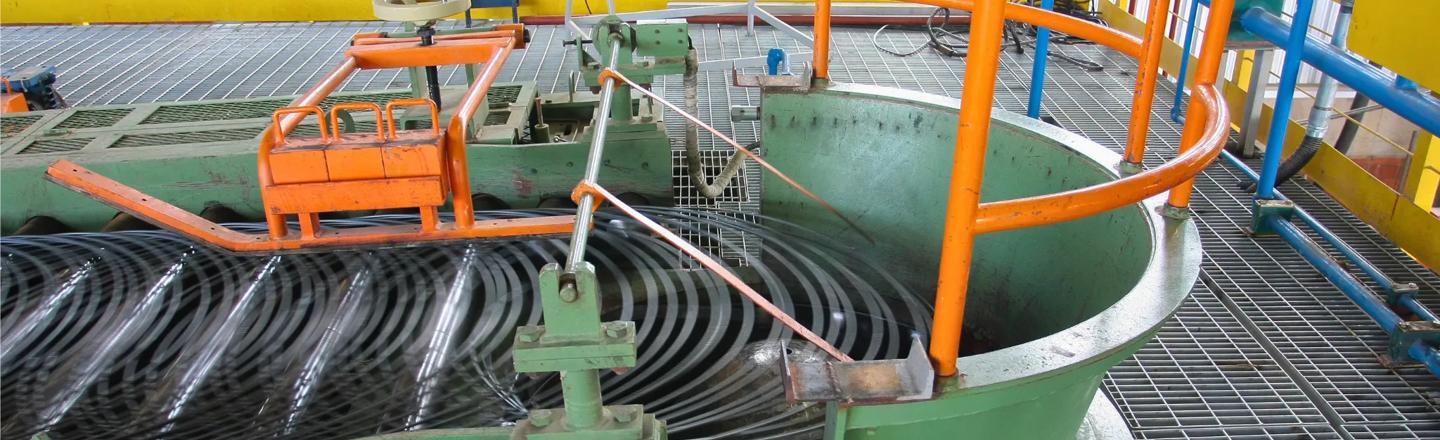 Side view of wire rod reform tub collecting and accurately forming coil