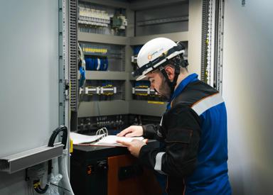 Maintenance engineer in front of control panel