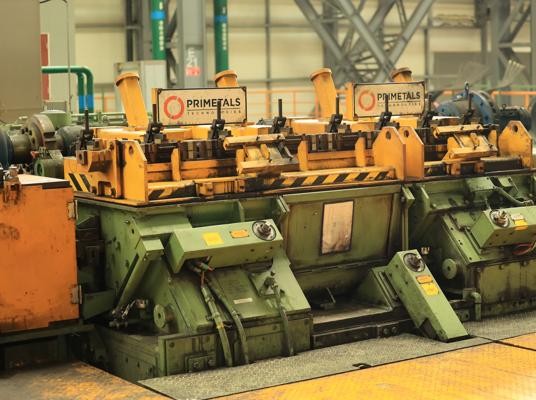 This photo shows the Morgan High Speed Laying Head as it lays stainless steel coiled bar onto the cooling conveyor.