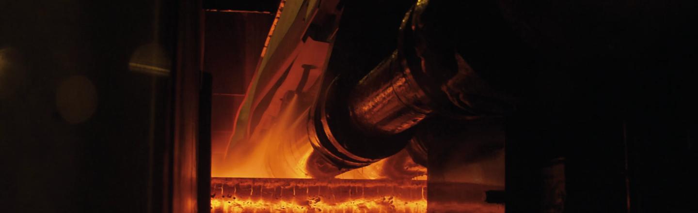 Continuous casting process with glowing steel strand passing through rollers in the mold area for stable casting operation