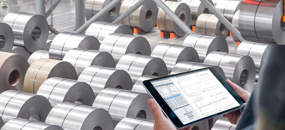 Coil yard with man standing in front having a tablet in his hands