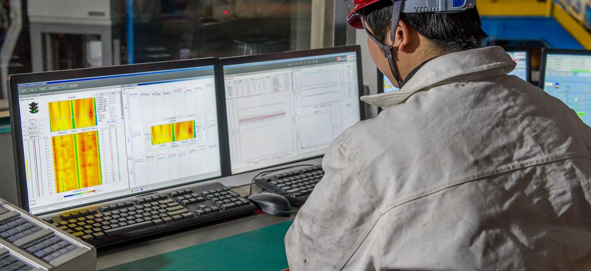 An operator sits in front of an HMI screen, actively monitoring and controlling the Endless Strip Production Line, ensuring smooth operation and consistent product quality.