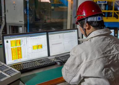 An operator sits in front of an HMI screen, actively monitoring and controlling the Endless Strip Production Line, ensuring smooth operation and consistent product quality.