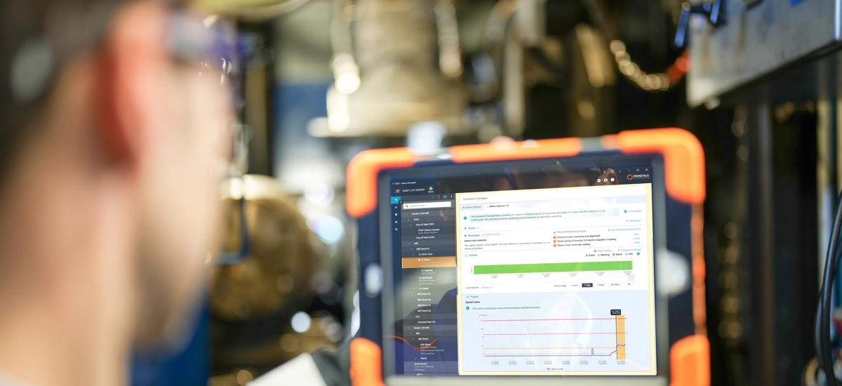  Maintenance engineer holding a tablet displaying an HMI screen with real-time condition monitoring data of the rolling mill, evaluating equipment detailed status and performance to ensure optimal operation and timely maintenance.