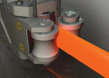 Hot steel bar exiting a roller guide in a long rolling mill, demonstrating product alignment and material handling techniques covered in guide system and roll pass training.