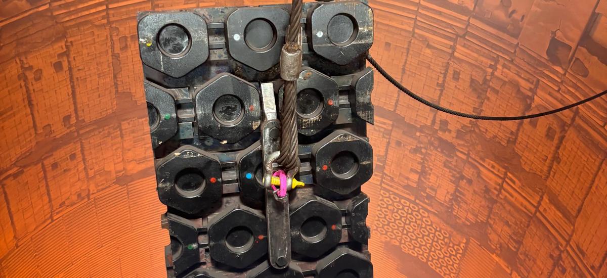 Wear-resistant copper stave with hexagonal inserts being lowered for installation into a blast furnace
