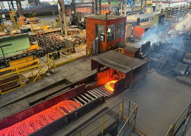 8-millimeter wire rod exiting laying head onto cooling conveyor at Stahl Gerlafingen’s new wire rod mill from Primetals Technologies. 
