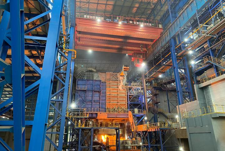 Electric Arc Furnace EAF Quantum in operation at Hubei Shunle, with the furnace area glowing and surrounded by large steel structures