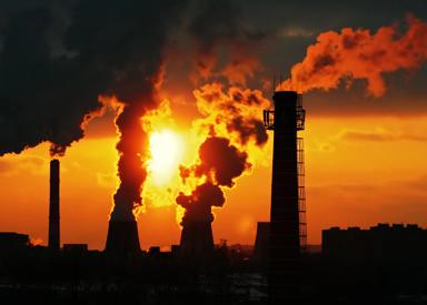 Image of emissions from an industrial plant at sunset.