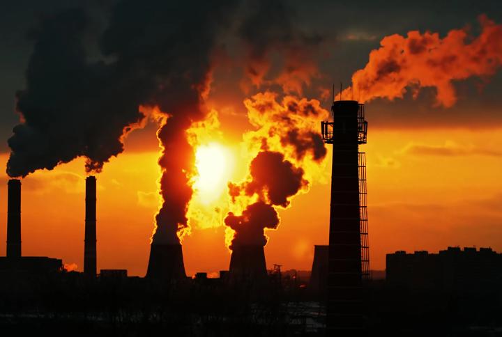 Image of emissions from an industrial plant at sunset.