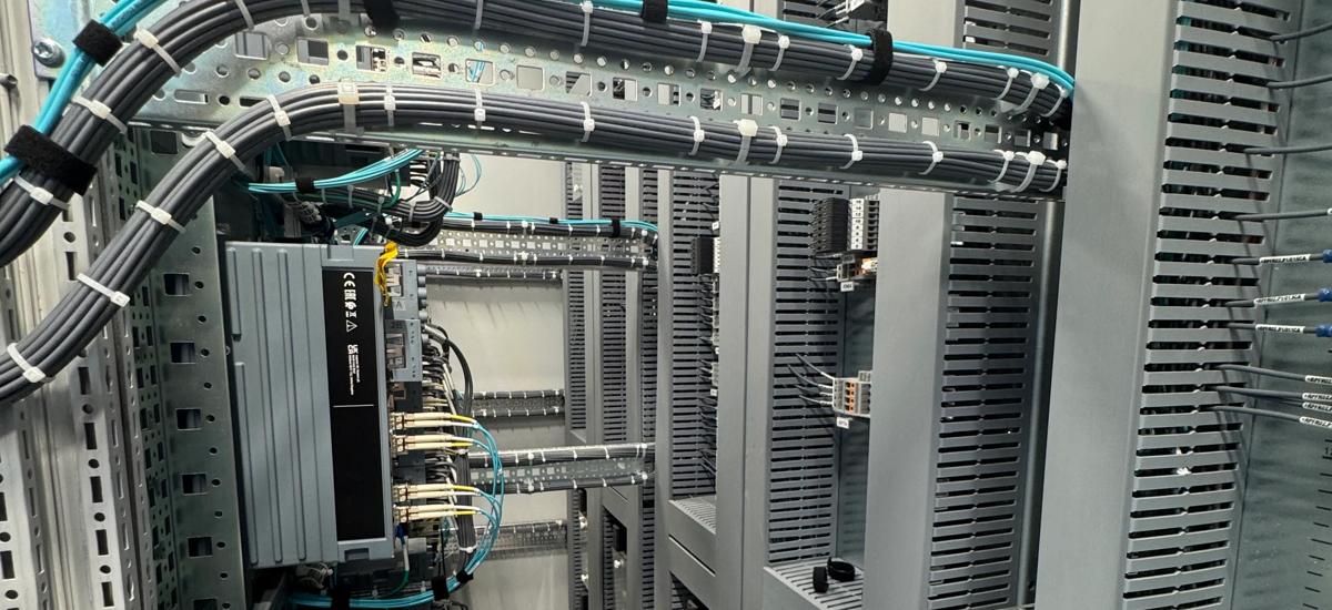 Interior view of a digital power substation control cabinet, showing organized cable routing and advanced automation components for precise and reliable operation in a steel plant environment.