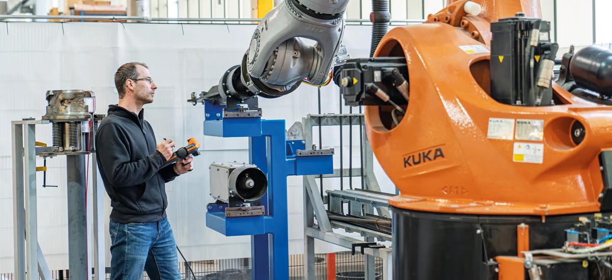 In the heart of the mechatronics workshop, Simon Pfeil works closely with the LiquiRob robot teaching new functionalities for future applications.