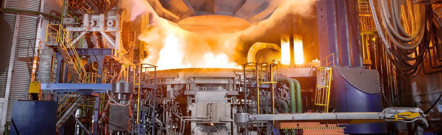 Scrap bucket charging scrap to an EAF Ultimate electric arc furnace
