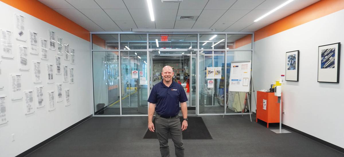 Head of Manufacturing Todd Cournoyer stands by the gate that connects the office area with the 13,000-square-meter workshop at te Sutton site.