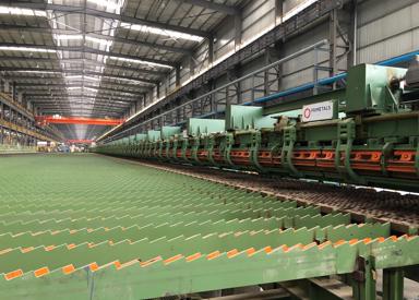 Rotary Entry System operating above the cooling bed in a high‑speed rebar mill