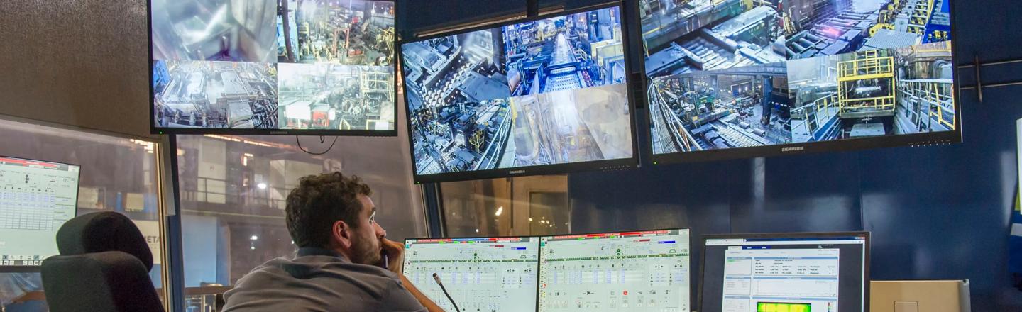Operator sitting in pulpit and monitoring screens