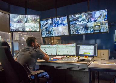 Operator sitting in pulpit and monitoring screens