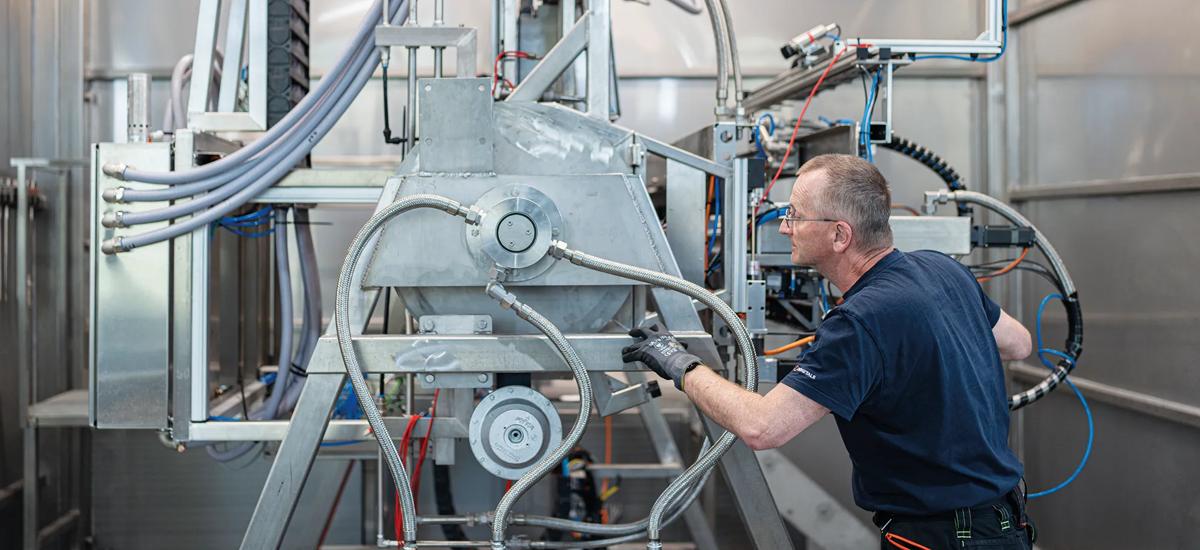 Klaus Rosenblattl closely examines the HTC test stand to ensure everything is in working order for upcoming tests on slab samples.