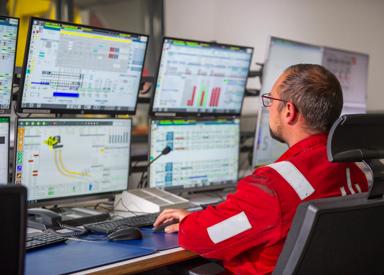 Steelworks employee at caster pulpit reviewing monitors featuring DynaPhase, Dynacs 3d, and DynaGap Soft Reduction.